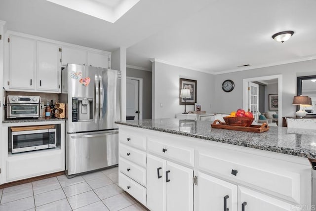 1093 Rancho Santa Fe Rd, Encinitas, CA 92024 - kitchen featuring stainless steel appliances, light tile patterned floors, dark stone counters, white cabinetry, and crown molding