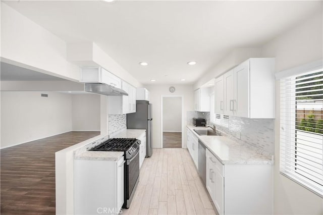 17435 Lassen St, Northridge, CA 91325 - kitchen with stainless steel appliances, under cabinet range hood, light wood-type flooring, recessed lighting, and decorative backsplash