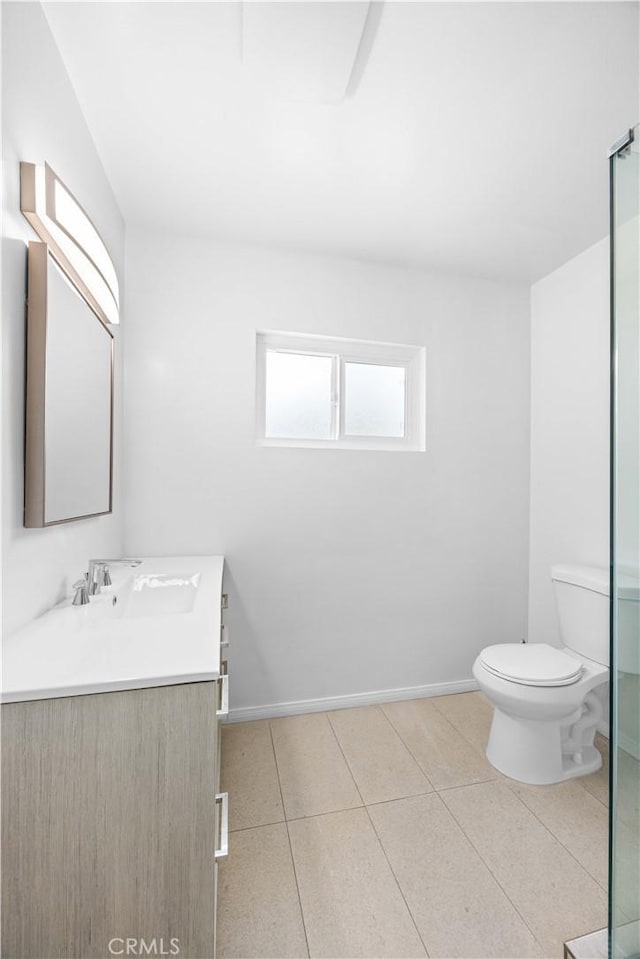 17435 Lassen St, Northridge, CA 91325 - full bathroom featuring vanity, toilet, tile patterned floors, baseboards, and a shower with shower door