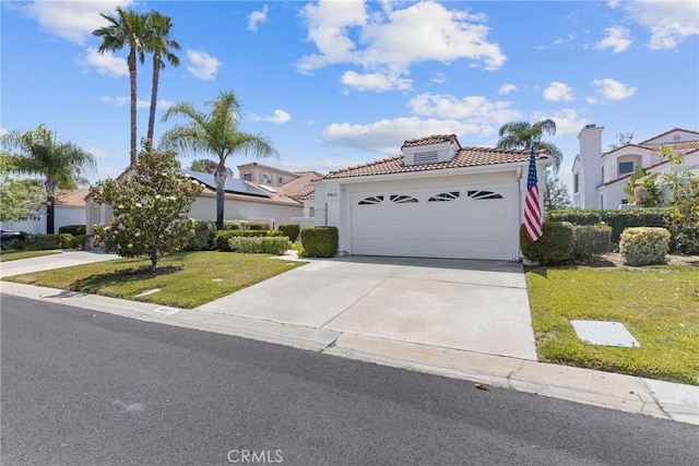 40612 Via Amapola, Murrieta, CA 92562 - mediterranean / spanish-style house with a tiled roof, a front lawn, driveway, stucco siding, and a residential view