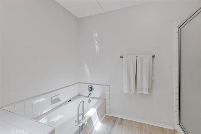 40612 Via Amapola, Murrieta, CA 92562 - bathroom featuring wood finished floors, a bath, a shower stall, and baseboards