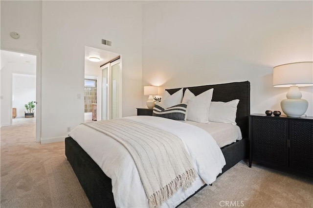 64 Sandpiper Unit 28, Irvine, CA 92604 - bedroom with light colored carpet, a towering ceiling, and baseboards