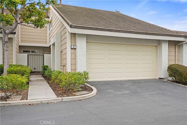 64 Sandpiper Unit 28, Irvine, CA 92604 - view of front of home featuring stucco siding and driveway