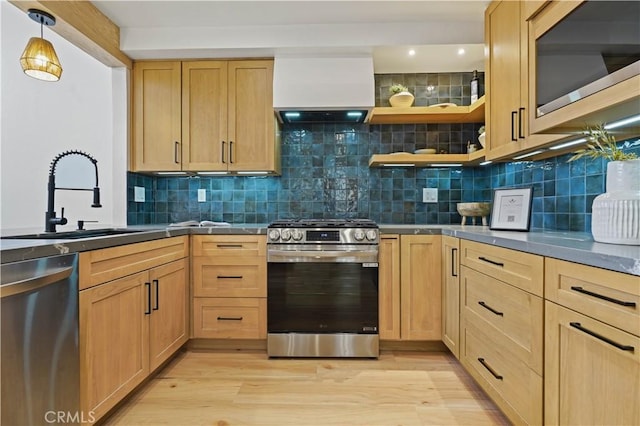 64 Sandpiper Unit 28, Irvine, CA 92604 - kitchen with stainless steel appliances, a sink, custom exhaust hood, dark countertops, and light brown cabinets