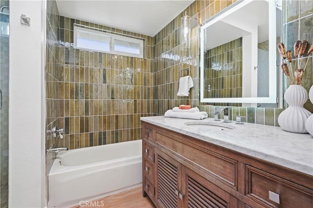 64 Sandpiper Unit 28, Irvine, CA 92604 - bathroom featuring vanity,  shower combination, and tile walls