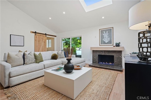 64 Sandpiper Unit 28, Irvine, CA 92604 - living area featuring a barn door, wood finished floors, recessed lighting, a fireplace, and high vaulted ceiling