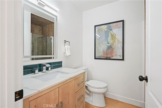 64 Sandpiper Unit 28, Irvine, CA 92604 - full bathroom featuring vanity, toilet, baseboards, tiled shower, and wood finished floors
