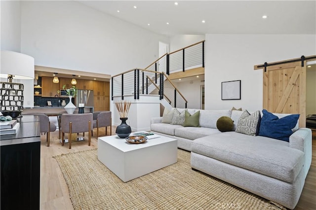 64 Sandpiper Unit 28, Irvine, CA 92604 - living area featuring high vaulted ceiling, a barn door, light wood finished floors, recessed lighting, and stairway