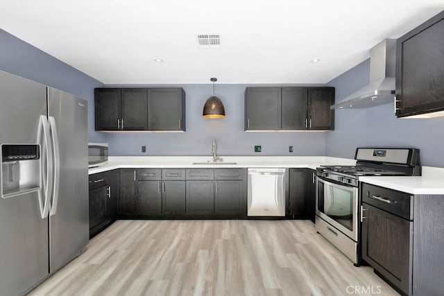 11230 Dilling St, Studio City, CA 91602 - kitchen featuring appliances with stainless steel finishes, a sink, wall chimney exhaust hood, light wood-style flooring, and light countertops
