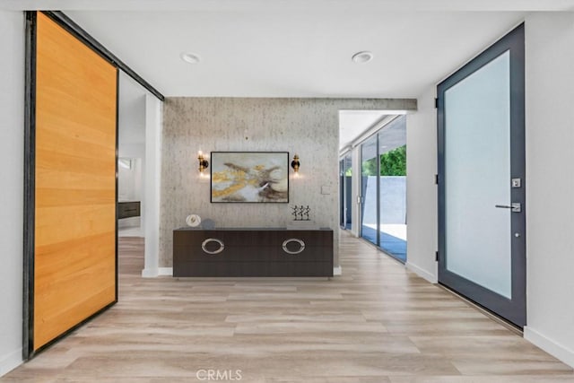 11230 Dilling St, Studio City, CA 91602 - hall featuring an accent wall, baseboards, wood finished floors, recessed lighting, and floor to ceiling windows