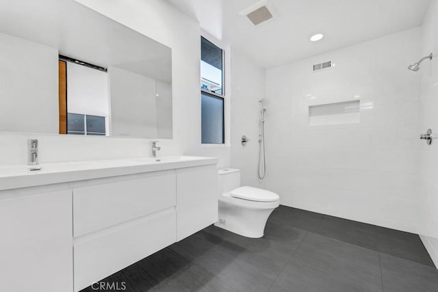 11230 Dilling St, Studio City, CA 91602 - bathroom featuring double vanity, toilet, and tiled shower