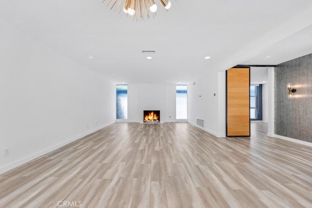 11230 Dilling St, Studio City, CA 91602 - unfurnished living room featuring light wood finished floors, a lit fireplace, baseboards, a chandelier, and recessed lighting