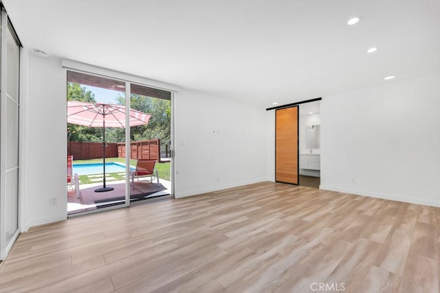 11230 Dilling St, Studio City, CA 91602 - unfurnished room featuring light wood-style flooring, recessed lighting, a barn door, and baseboards