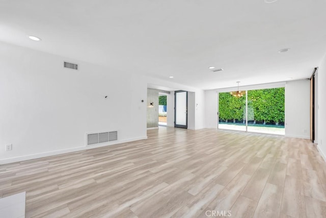 11230 Dilling St, Studio City, CA 91602 - unfurnished living room with light wood-style flooring, recessed lighting, baseboards, and a wall of windows
