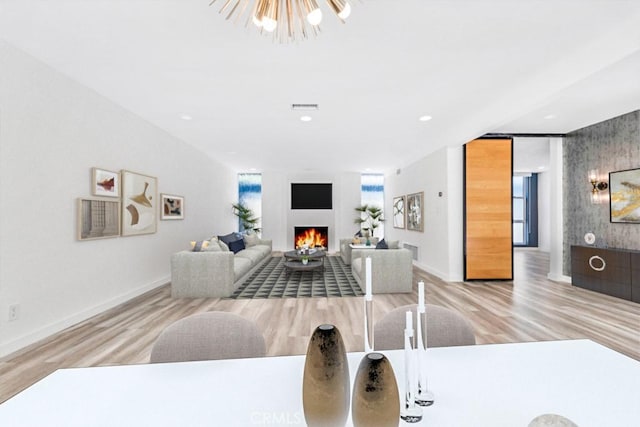 11230 Dilling St, Studio City, CA 91602 - dining area with a lit fireplace, wood finished floors, baseboards, and recessed lighting