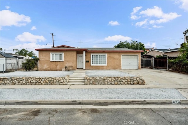 820 Carlotta Ct, Redlands, CA 92374 - view of front of property featuring stucco siding, an attached garage, and driveway