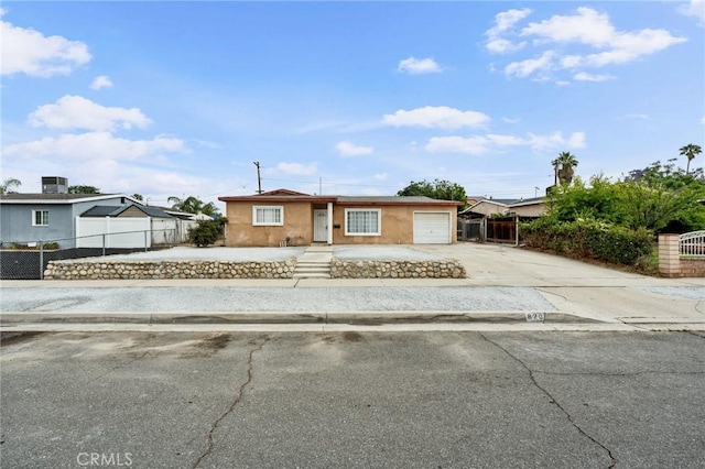 820 Carlotta Ct, Redlands, CA 92374 - view of front facade with concrete driveway, an attached garage, and stucco siding