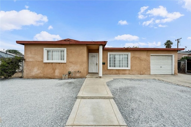 820 Carlotta Ct, Redlands, CA 92374 - ranch-style house with stucco siding, a garage, and driveway