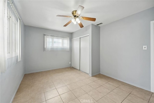820 Carlotta Ct, Redlands, CA 92374 - unfurnished bedroom with a closet, light tile patterned floors, a ceiling fan, and baseboards