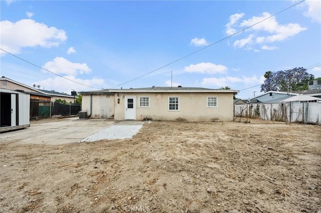 820 Carlotta Ct, Redlands, CA 92374 - back of house featuring a fenced backyard, stucco siding, central AC, and a patio area