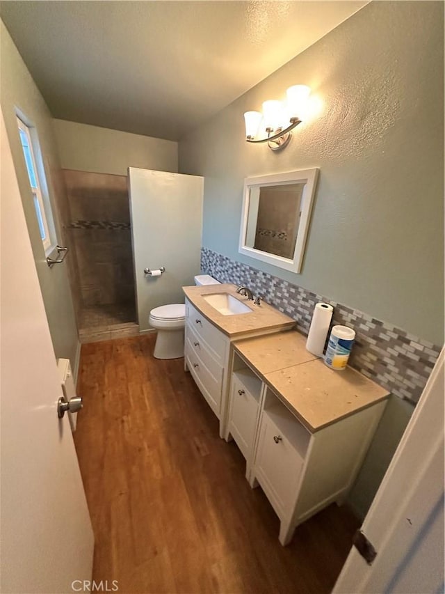 618 Award Dr, Colton, CA 92324 - bathroom with toilet, a tile shower, wood finished floors, and vanity