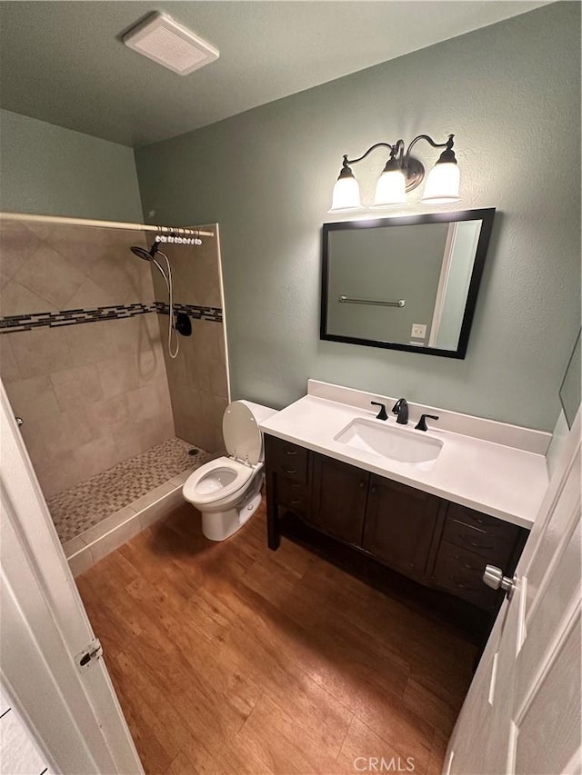 618 Award Dr, Colton, CA 92324 - bathroom featuring a shower stall, toilet, vanity, and wood finished floors