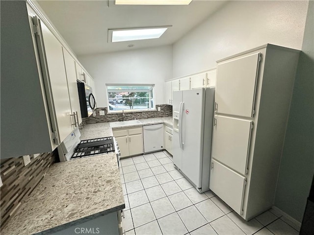 618 Award Dr, Colton, CA 92324 - kitchen featuring white appliances, decorative backsplash, a sink, light tile patterned flooring, and light countertops