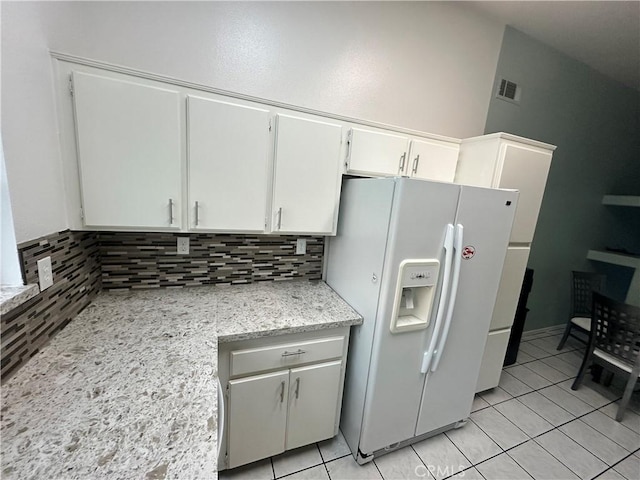 618 Award Dr, Colton, CA 92324 - kitchen with white refrigerator with ice dispenser, backsplash, white cabinets, and light tile patterned floors