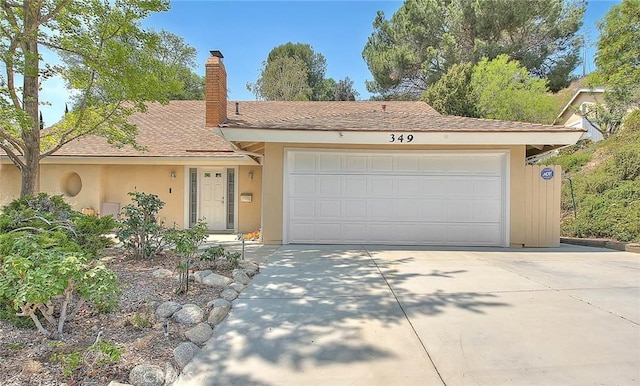 349 N Del Sol Ln, Diamond Bar, CA 91765 - view of front of home with a chimney, stucco siding, an attached garage, and driveway