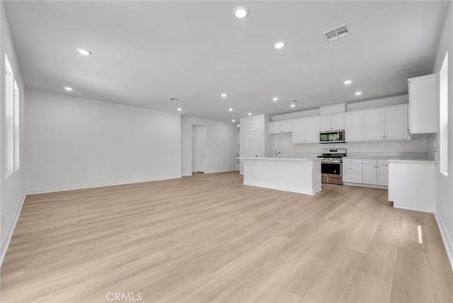 4742 S Scott Way, Ontario, CA 91762 - kitchen with appliances with stainless steel finishes, open floor plan, recessed lighting, light countertops, and white cabinetry