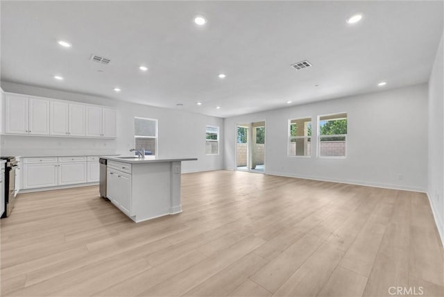 4742 S Scott Way, Ontario, CA 91762 - kitchen with open floor plan, appliances with stainless steel finishes, recessed lighting, white cabinets, and light wood-style floors