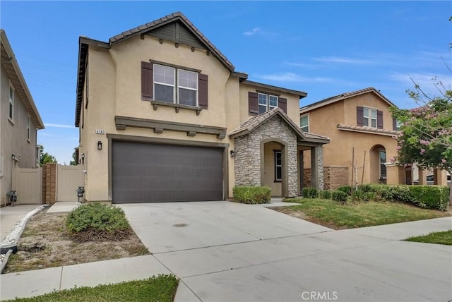 4742 S Scott Way, Ontario, CA 91762 - traditional home with stucco siding, an attached garage, driveway, a gate, and stone siding
