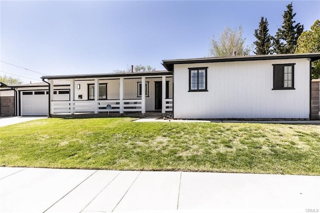 1222 W Kettering St, Lancaster, CA 93534 - view of front of property with an attached garage, a front yard, driveway, and covered porch