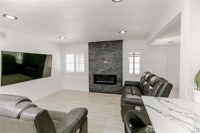 1222 W Kettering St, Lancaster, CA 93534 - living area featuring light wood-style floors, a fireplace, and recessed lighting