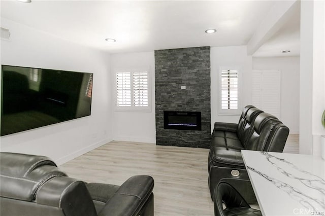 1222 W Kettering St, Lancaster, CA 93534 - living area with plenty of natural light, wood finished floors, a fireplace, and recessed lighting