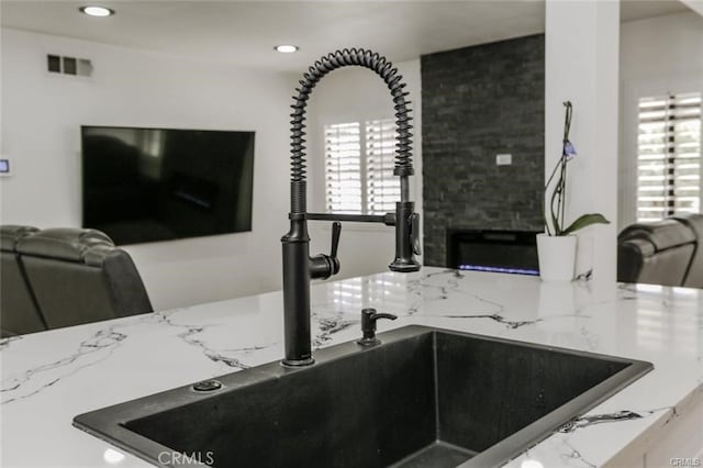 1222 W Kettering St, Lancaster, CA 93534 - kitchen featuring light stone countertops, recessed lighting, and a fireplace