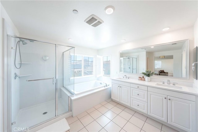 6940 Lagoon Ct, Jurupa Valley, CA 91752 - full bathroom with double vanity, a garden tub, a shower stall, and tile patterned flooring