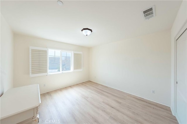 6940 Lagoon Ct, Jurupa Valley, CA 91752 - unfurnished bedroom with light wood-style floors and a closet