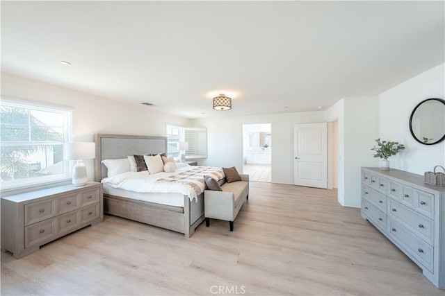 6940 Lagoon Ct, Jurupa Valley, CA 91752 - bedroom with light wood-style flooring and ensuite bathroom