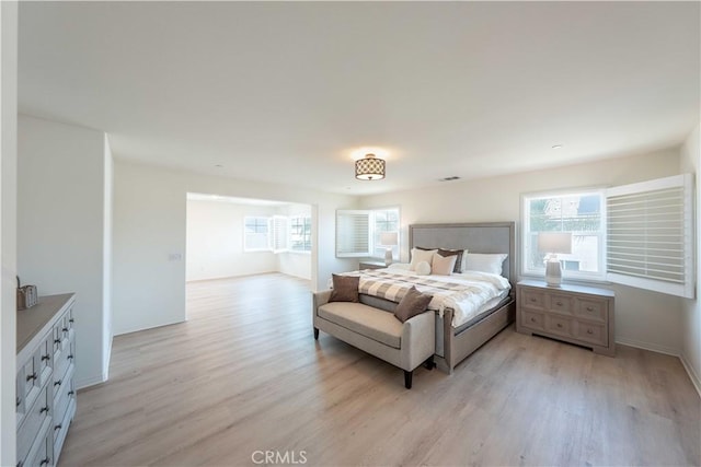 6940 Lagoon Ct, Jurupa Valley, CA 91752 - bedroom featuring light wood-style flooring and multiple windows