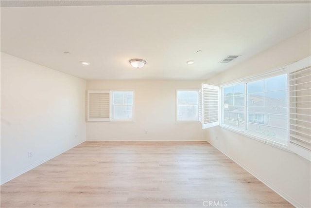 6940 Lagoon Ct, Jurupa Valley, CA 91752 - empty room featuring healthy amount of natural light, light wood-style floors, and recessed lighting