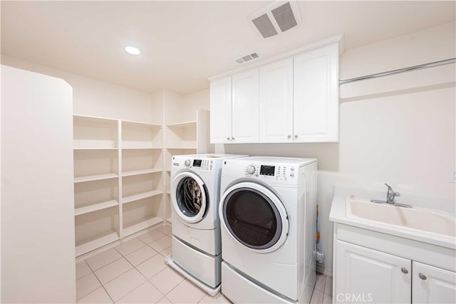 6940 Lagoon Ct, Jurupa Valley, CA 91752 - washroom featuring washer and clothes dryer, cabinet space, light tile patterned floors, and recessed lighting