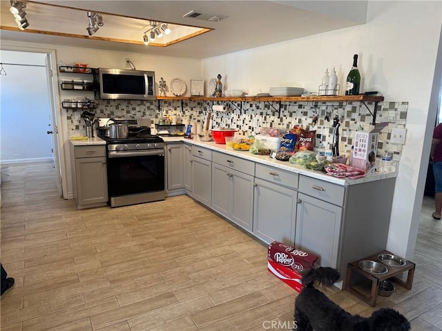 13484 Franceska Rd, Apple Valley, CA 92308 - kitchen with open shelves, appliances with stainless steel finishes, gray cabinetry, and light wood-style floors