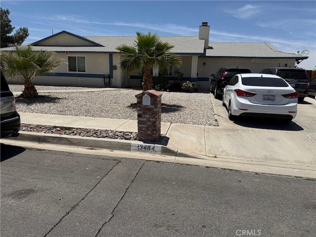 13484 Franceska Rd, Apple Valley, CA 92308 - ranch-style house featuring concrete driveway, a garage, and a chimney