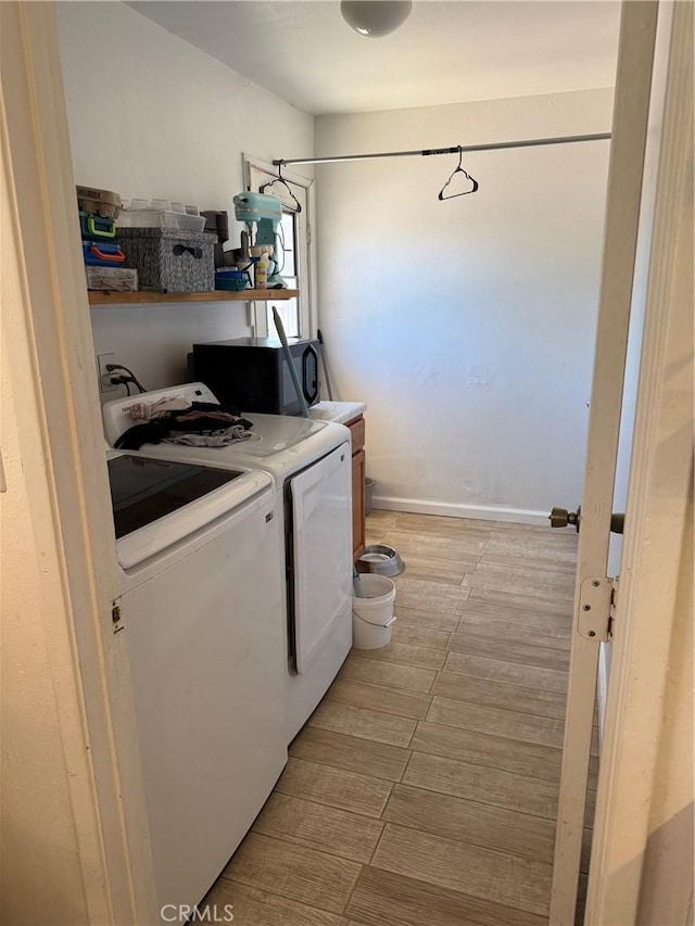 13484 Franceska Rd, Apple Valley, CA 92308 - laundry room featuring washing machine and clothes dryer, cabinet space, and light wood-type flooring