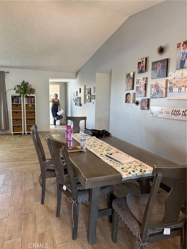 13484 Franceska Rd, Apple Valley, CA 92308 - dining space with vaulted ceiling, a textured ceiling, and wood finished floors