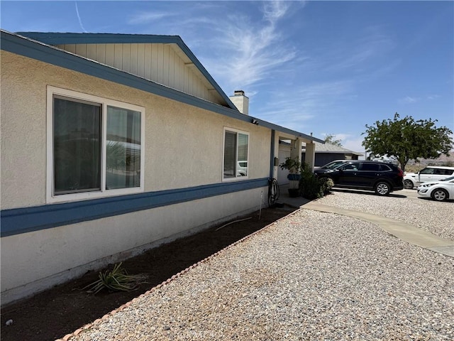 13484 Franceska Rd, Apple Valley, CA 92308 - view of side of property featuring a chimney and stucco siding