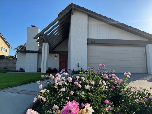 135 Ricci Ave, Walnut, CA 91789 - mid-century home with stucco siding, a chimney, concrete driveway, and a front lawn