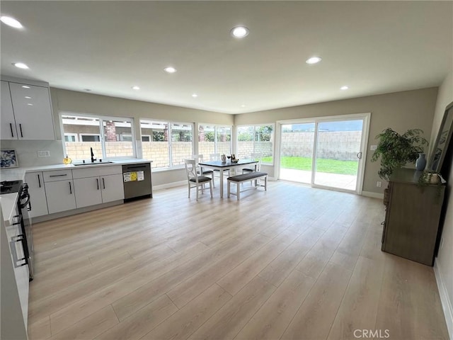 135 Ricci Ave, Walnut, CA 91789 - kitchen featuring dishwasher, a sink, baseboards, light wood-style floors, and recessed lighting