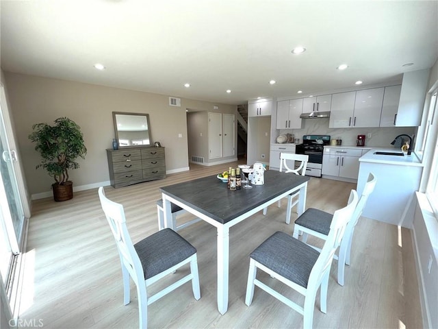 135 Ricci Ave, Walnut, CA 91789 - dining area featuring light wood-style flooring, recessed lighting, baseboards, and stairway